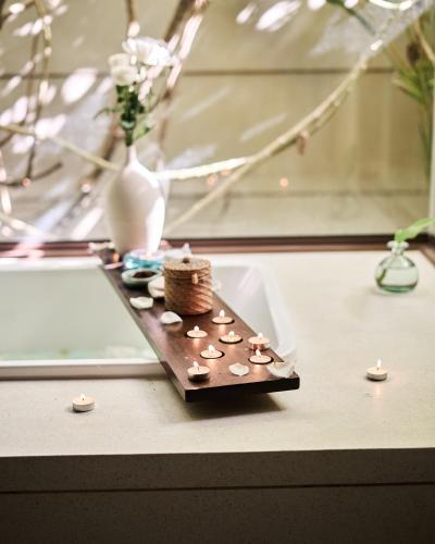 a table with a tray with coins and a vase at Maia Resort Quy Nhon in Quy Nhon