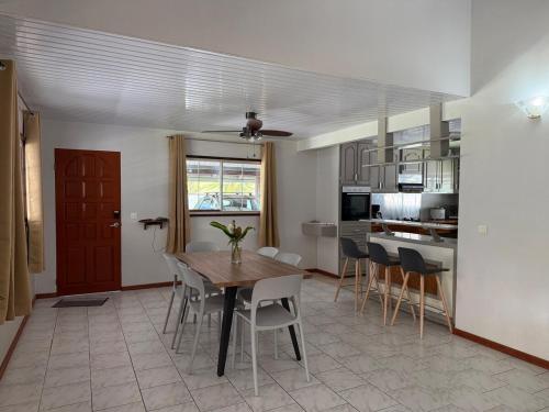 a kitchen and dining room with a table and chairs at Fare Matahani in HUH