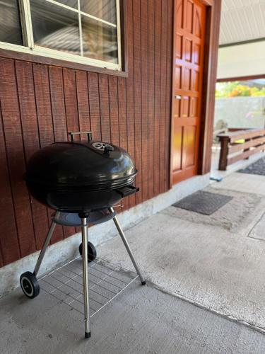 a charcoal grill sitting outside of a building at Fare Matahani in HUH