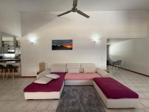 a bedroom with a large bed and a ceiling at Fare Matahani in HUH
