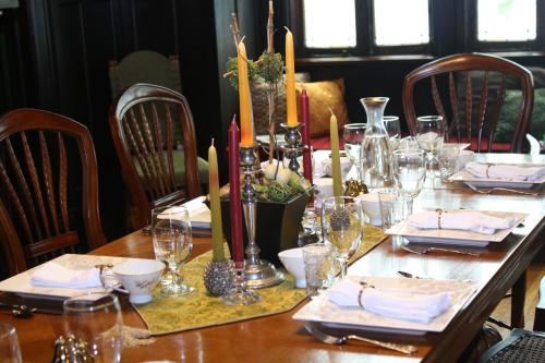 a wooden table with plates and glasses on it at Canal Street Inn in New Orleans