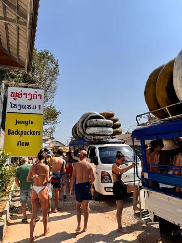 a group of people in bathing suits standing next to a truck at Jungle Backpackers View in Vang Vieng
