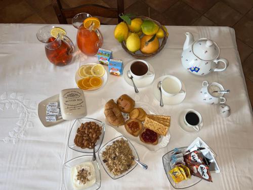 a table with breakfast foods and coffee on it at Torre Archirafi Resort in Riposto