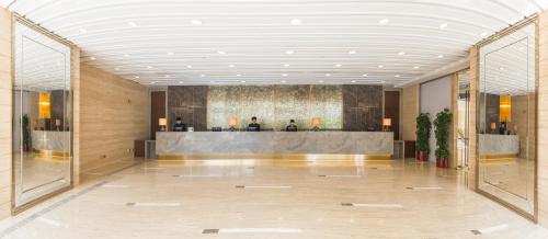 a lobby with a reception desk in a building at Kowloon Harbourfront Hotel in Hong Kong