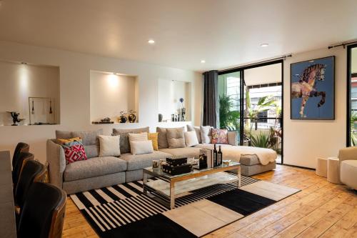 a living room with a couch and a table at URBAN HOUSE I Prime Location I 6 Bedrooms I Old Town I Daily Housekeeping in Chiang Mai