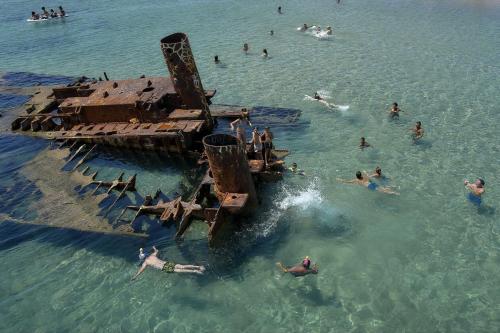 a group of people swimming in the ocean at DREAM house by the sea in Epanomi