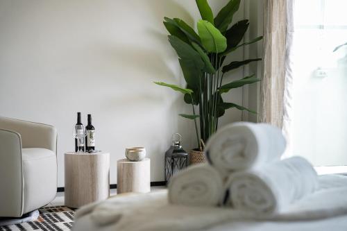 a room with a plant and a pile of towels at URBAN HOUSE I Prime Location I 6 Bedrooms I Old Town I Daily Housekeeping in Chiang Mai