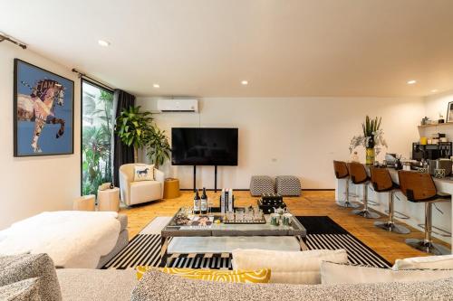 a living room with a couch and a table at URBAN HOUSE I Prime Location I 6 Bedrooms I Old Town I Daily Housekeeping in Chiang Mai