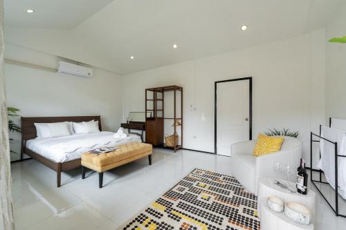 a bedroom with a bed and a table and a couch at URBAN HOUSE I Prime Location I 6 Bedrooms I Old Town I Daily Housekeeping in Chiang Mai