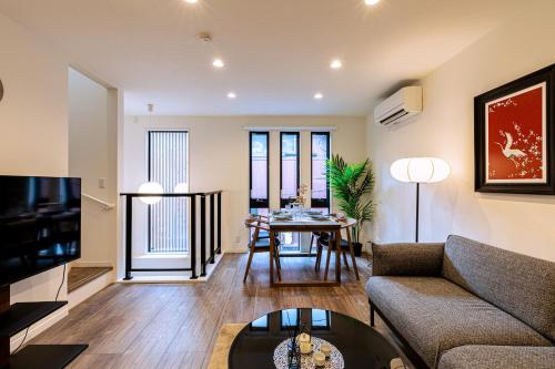 a living room with a couch and a table at JS暁宅-睦月 mutsuki in Osaka