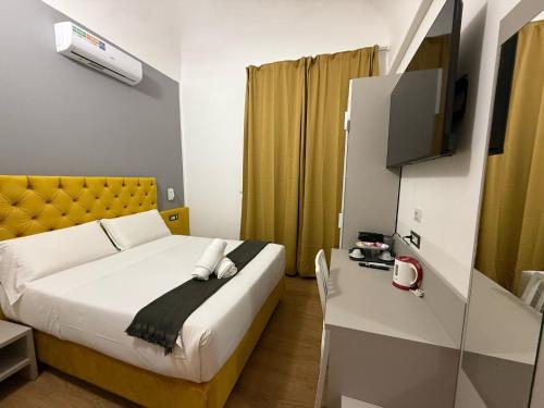 a hotel room with a bed and a tv at Conte GuestHouse in Rome