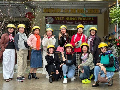 a group of women wearing yellow helmets posing for a picture at VIỆT HƯNG HÀ GIANG Hostel motorbikes for rental in Ha Giang