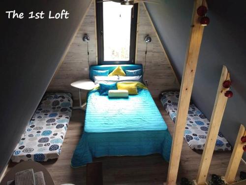a bedroom with a bed in a attic at DREAM house by the sea in Epanomi