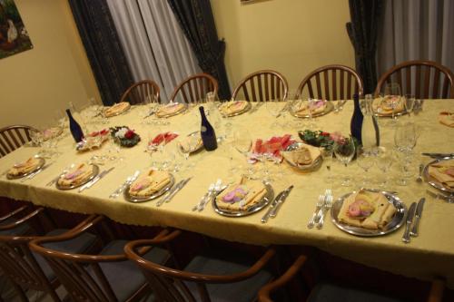 a table with plates of food on it at Hotel Tre Denti in Cantalupa