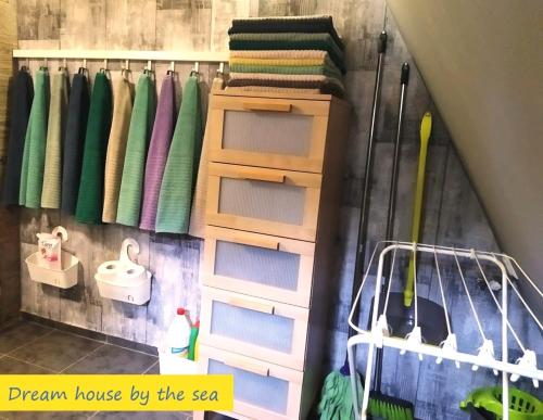 a rack of drawers and towels on a wall at DREAM house by the sea in Epanomi
