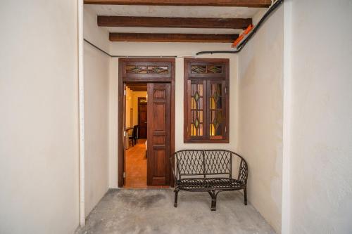 a bench sitting in a hallway with a door at Penang Story LINN House in George Town