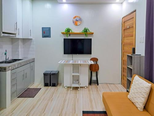 a living room with a tv and a kitchen at Sunset Suite Condo Style Stay with Motor Parking in Santo Cristo