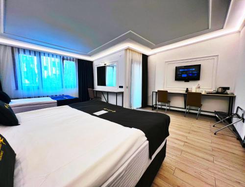 a hotel room with a large bed and a television at Angel's Home Suites - Angel Group Hotels in Istanbul