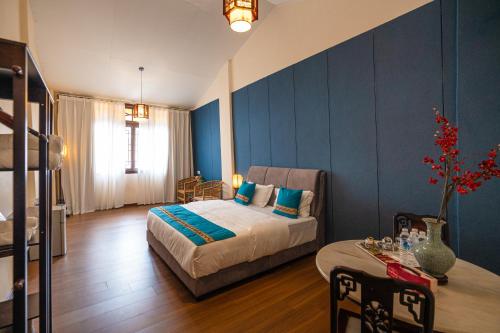 a bedroom with a bed and a table at Penang Story LINN House in George Town