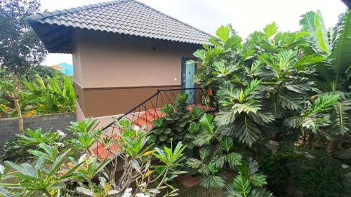 a house with a balcony and trees in front of it at ZEN garden in Xuyên Mộc
