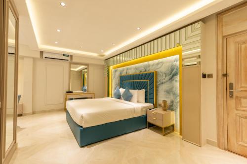 a bedroom with a bed with a painting on the wall at Marine Bay Colombo in Colombo