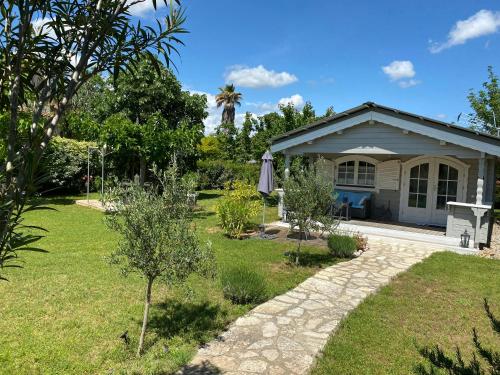 a house with a garden in front of it at Chalet de Charme in Aniane
