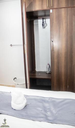 a bathroom with a mirror and a towel on a bed at Royal apartments Eldoret in Eldoret