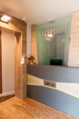 an office with a reception desk and a sign at Семеен Хотел Олимп in Sopot