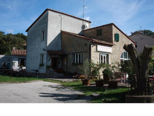 an old stone building with plants in front of it at La Palazzina in Chiusdino