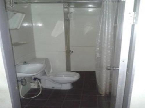 a bathroom with a toilet and a sink at T8 Guest House Don Mueang Challenger in Bangkok