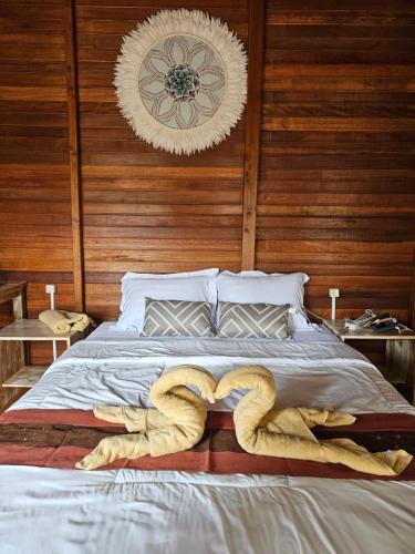 a bedroom with a bed with two snakes on it at Amore in Labuan Bajo