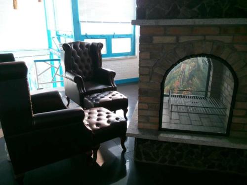 a living room with two chairs and a fireplace at Home of the Great Wall in Huairou