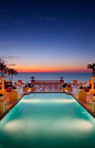 a swimming pool with a sunset in the background at Hyatt Regency Clearwater Beach Resort & Spa in Clearwater Beach