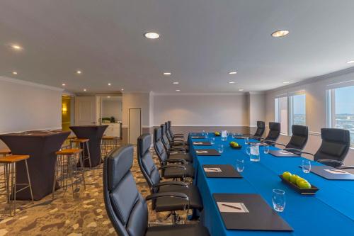 a conference room with a long blue table and chairs at Hyatt Regency Clearwater Beach Resort & Spa in Clearwater Beach