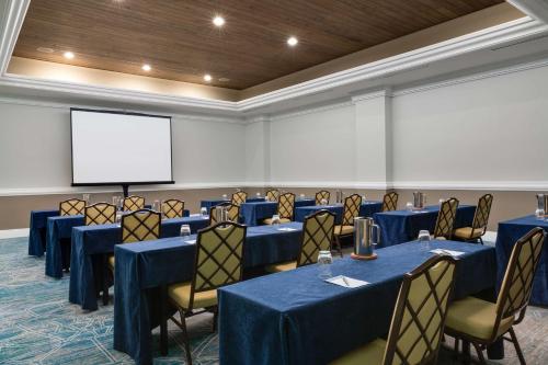 a conference room with blue tables and chairs and a screen at Hyatt Regency Clearwater Beach Resort & Spa in Clearwater Beach