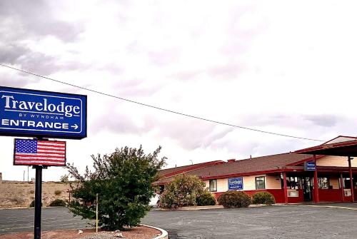 a building with a sign in front of a store at Travelodge by Wyndham Truth or Consequences in Truth or Consequences