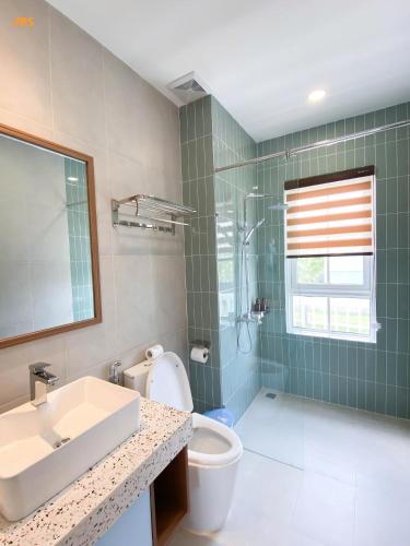 a bathroom with a sink and a toilet at Novaworld Phan Thiet in Bình Sum