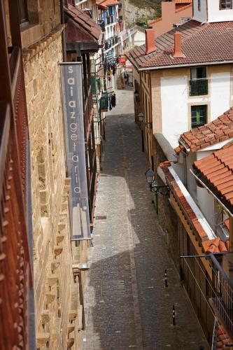 an empty alley between buildings in a city at Saiaz Getaria Hotela in Getaria