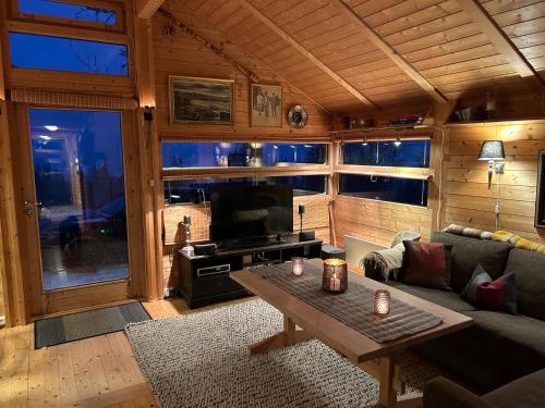 a living room with a couch and a table in a cabin at Orrelie by Norgesbooking - cabin with a lovely view in Ål