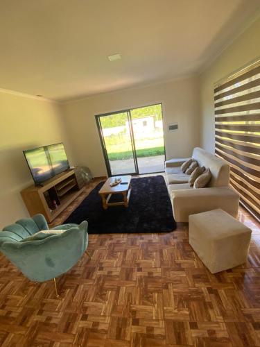 a living room with a couch and a table at Cabañas mi refugio salto del laja in Salto del Laja