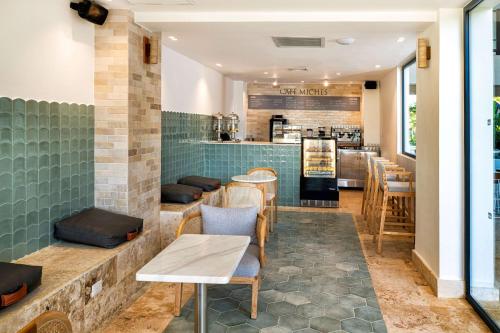 a restaurant with a bar with tables and chairs at Viva Miches by Wyndham, a Trademark All Inclusive Resort in Miches
