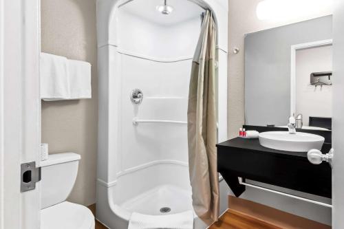 a bathroom with a shower and a toilet and a sink at Econo Lodge in Idaho Falls