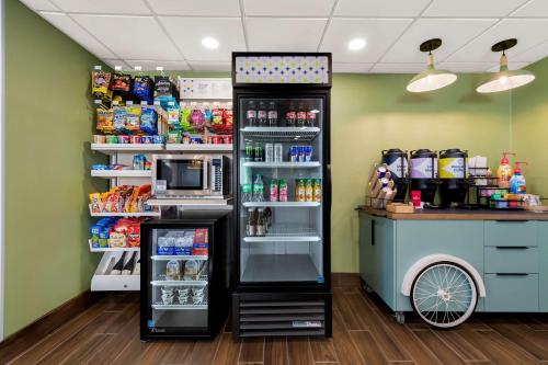 a refrigerator is next to a counter in a store at Spark by Hilton Norfolk in Norfolk