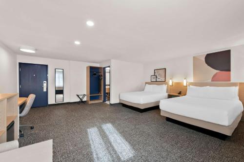 a hotel room with two beds and a tv at Spark by Hilton Norfolk in Norfolk