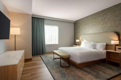 a hotel room with a bed and a window at Sea Glass Beach Place, Trademark Collection by Wyndham in Fort Lauderdale