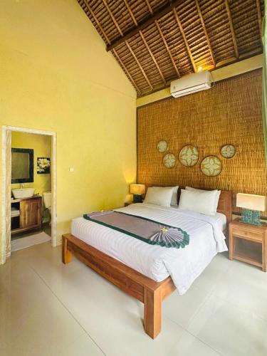a bedroom with a large bed in a room at Nusa Majesty in Nusa Penida
