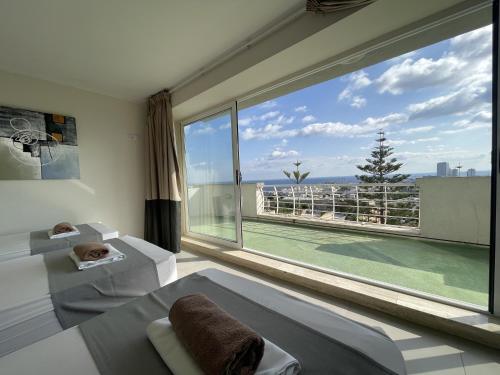 a room with a large window with a view of a tennis court at Villa Diamantina in St Julian's