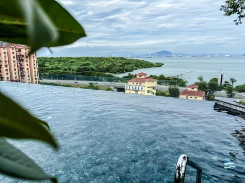 a view of the water from a swimming pool at Urban Suites George Town in Jelutong