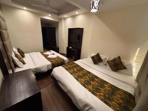 a hotel room with two beds in a room at The Bunkk Inn Hotel & Restaurant in Mussoorie