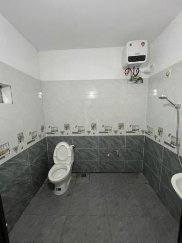 a bathroom with a toilet and a sink at Lalaland Villa Mộc Châu in Mộc Châu